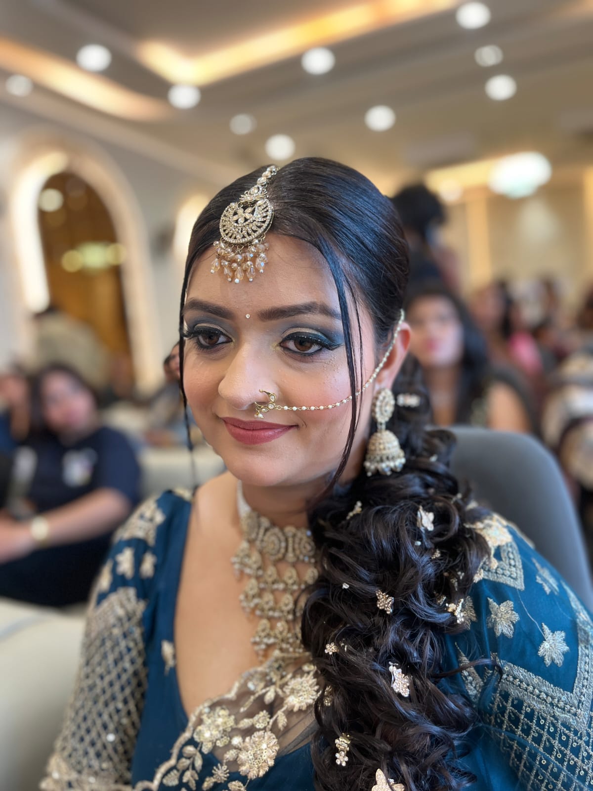 Side portrait showing bridal makeup and braided hairstyle.