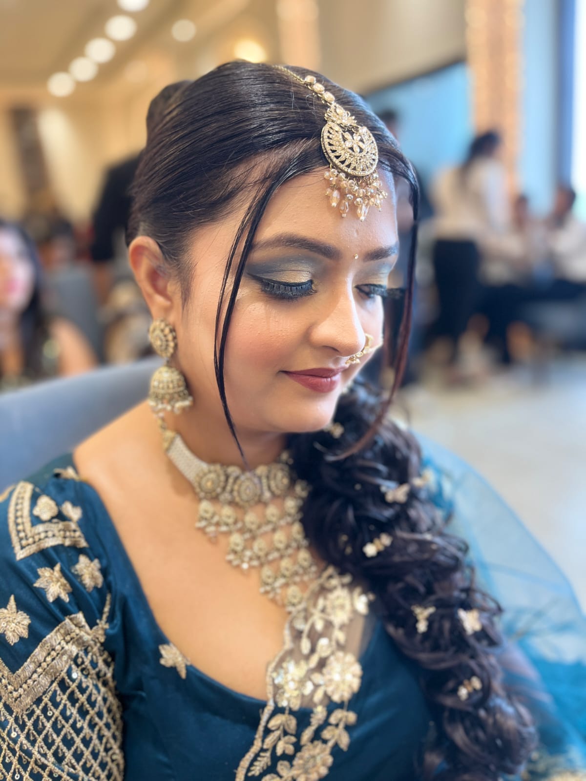 Side profile showing bridal makeup and jewellery styling.