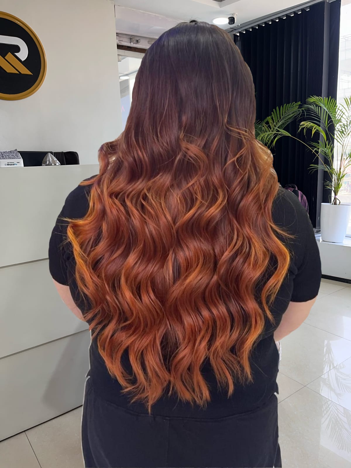 Long copper-toned wavy hair finish.