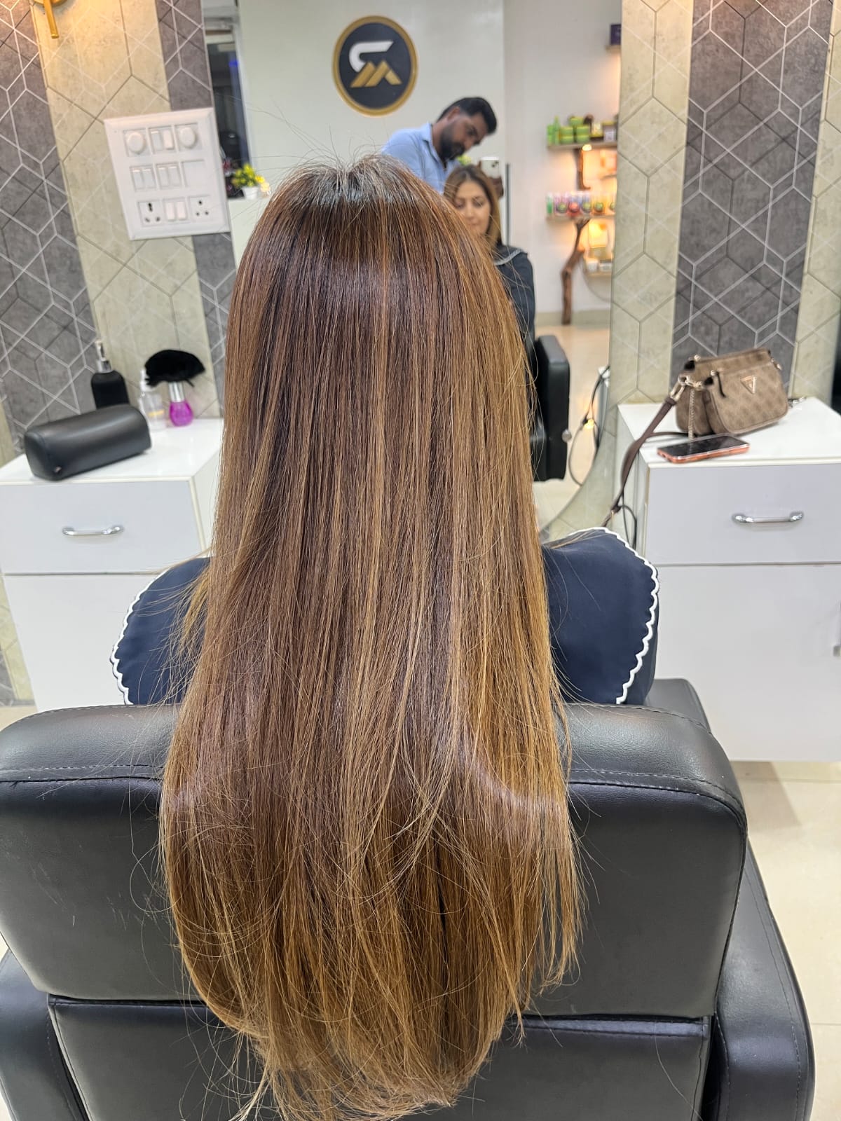 Long straight hair finish in a salon setting.
