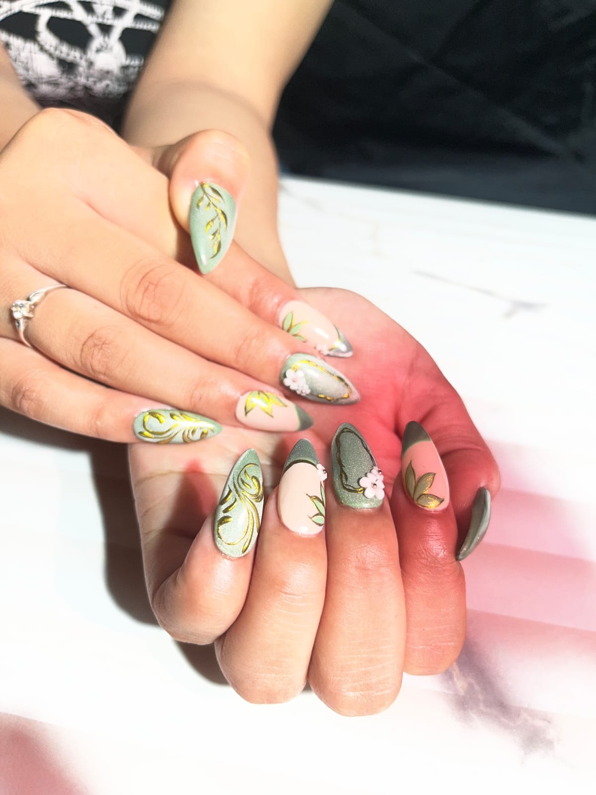 Close view of floral and gold nail art.